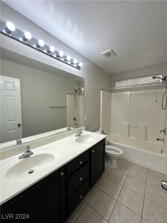 full bathroom with vanity, bathtub / shower combination, tile patterned flooring, toilet, and a textured ceiling