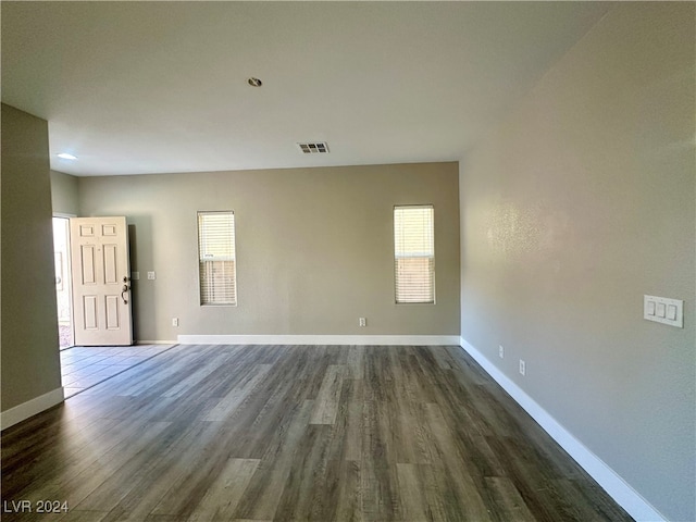 spare room with dark hardwood / wood-style flooring