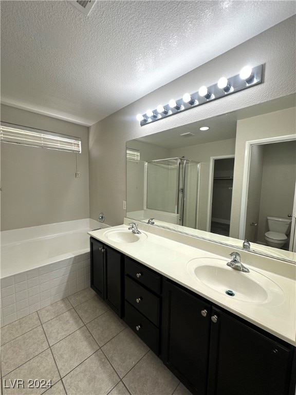 full bathroom featuring plus walk in shower, tile patterned flooring, a textured ceiling, toilet, and vanity