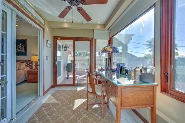 sunroom featuring ceiling fan