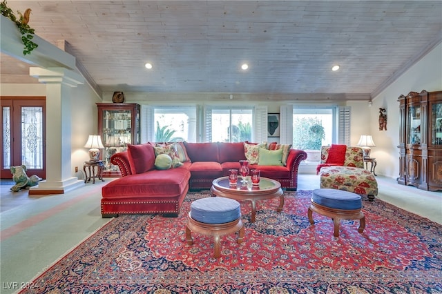 living room with ornamental molding, light carpet, and decorative columns