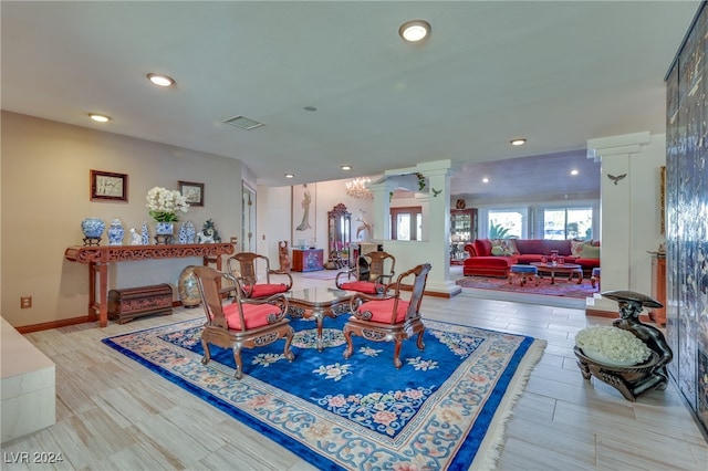 dining area with wood-type flooring and decorative columns