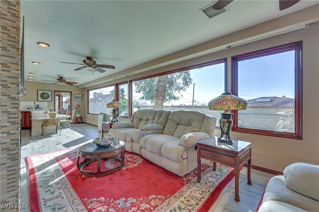 living room with ceiling fan and light hardwood / wood-style floors