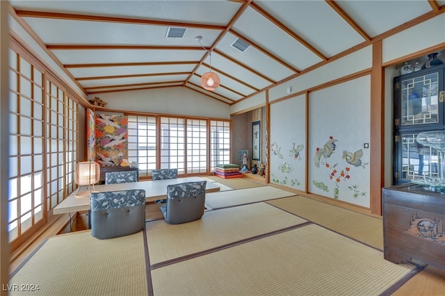 interior space featuring vaulted ceiling with beams