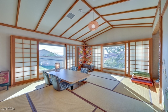 dining space featuring vaulted ceiling and a wealth of natural light