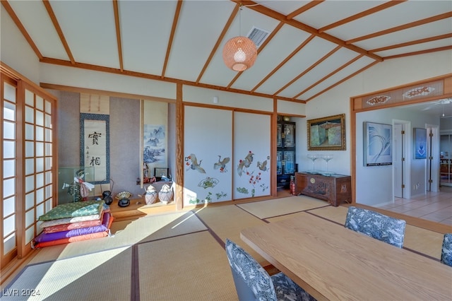 interior space featuring tile patterned flooring and lofted ceiling