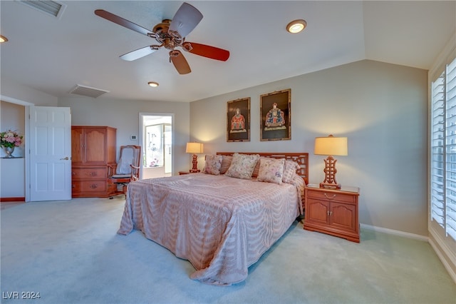 carpeted bedroom featuring multiple windows, ceiling fan, and lofted ceiling