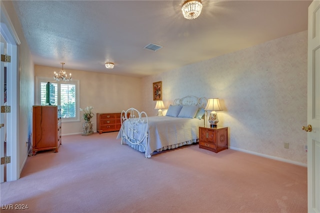 bedroom with carpet flooring and a notable chandelier