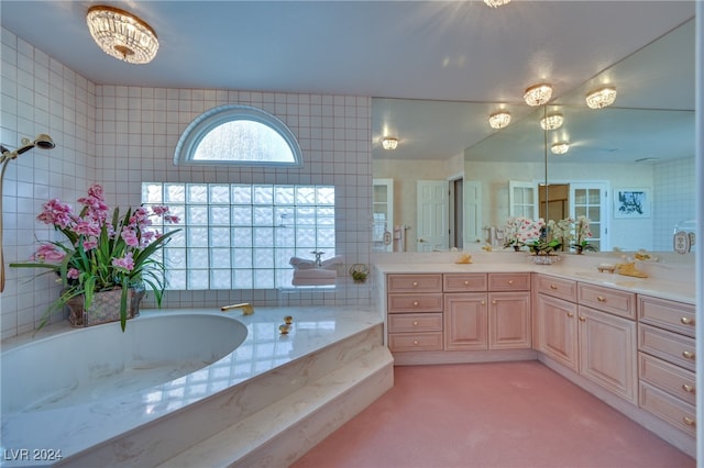 bathroom featuring a bathtub, vanity, and an inviting chandelier