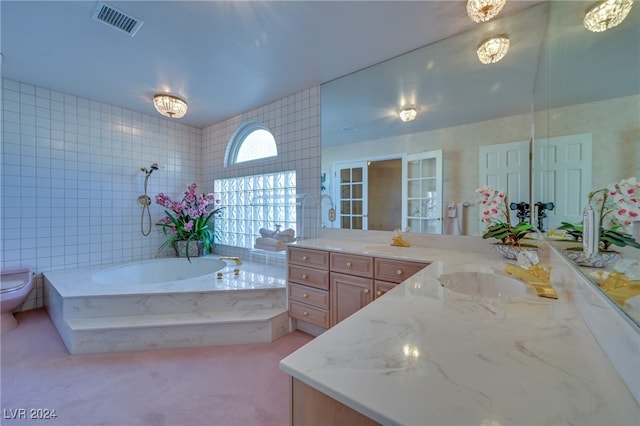 full bathroom with french doors, separate shower and tub, toilet, vanity, and tile walls