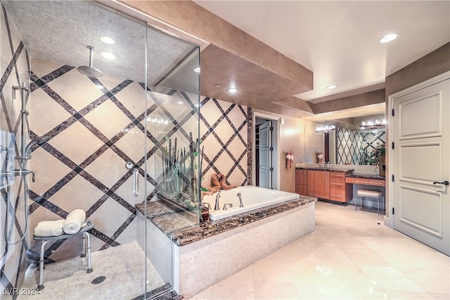 bathroom with vanity, tile patterned flooring, and plus walk in shower