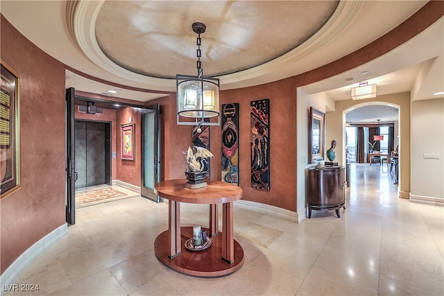 hallway featuring a tray ceiling