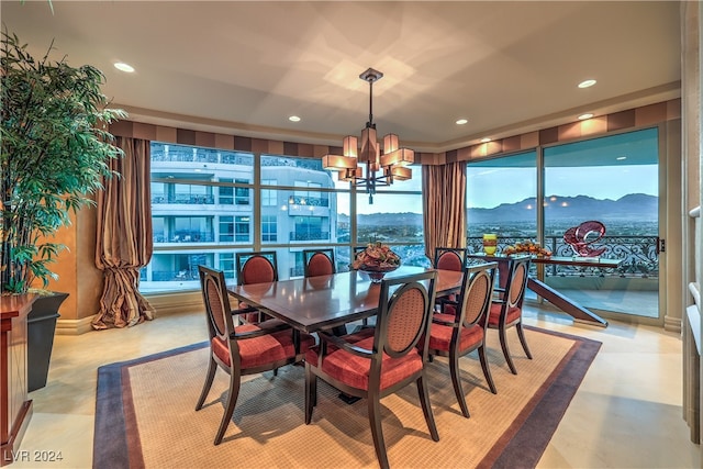 dining room featuring a mountain view and a notable chandelier