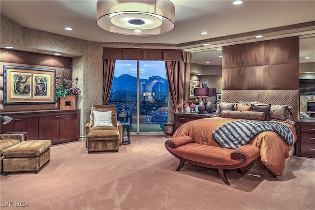 carpeted bedroom featuring a mountain view and access to exterior