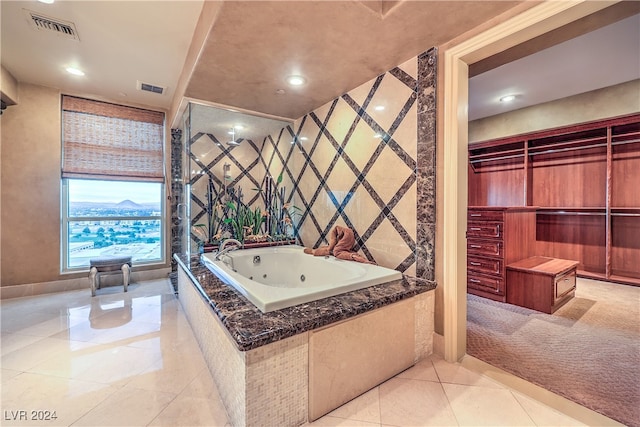 bathroom featuring tile patterned flooring and a tub to relax in