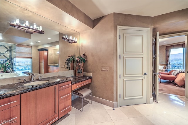 bathroom featuring vanity, tile patterned floors, and a healthy amount of sunlight