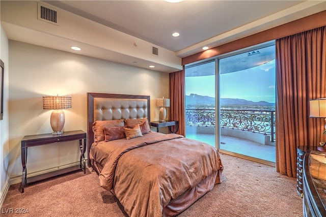 bedroom with carpet, a mountain view, and access to exterior