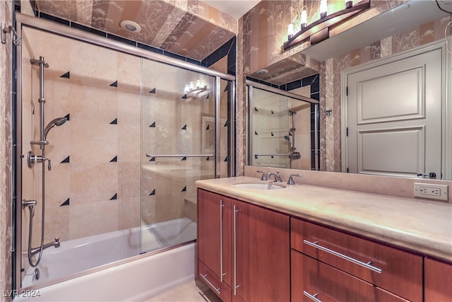 bathroom with vanity and shower / bath combination with glass door