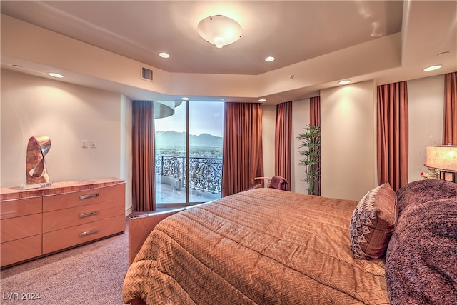 carpeted bedroom featuring a mountain view and access to outside