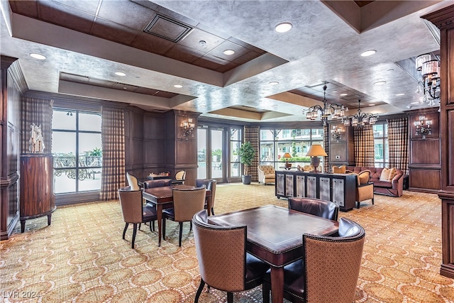 dining room with a raised ceiling and a healthy amount of sunlight