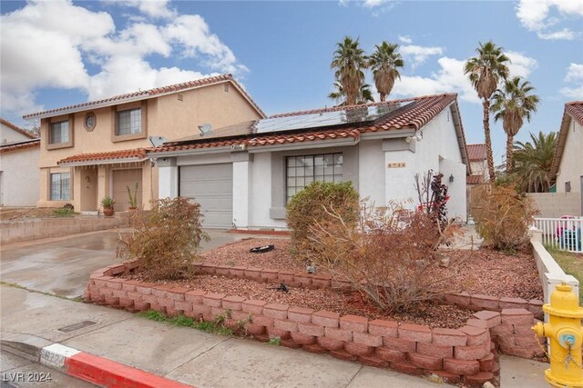 mediterranean / spanish-style home featuring solar panels