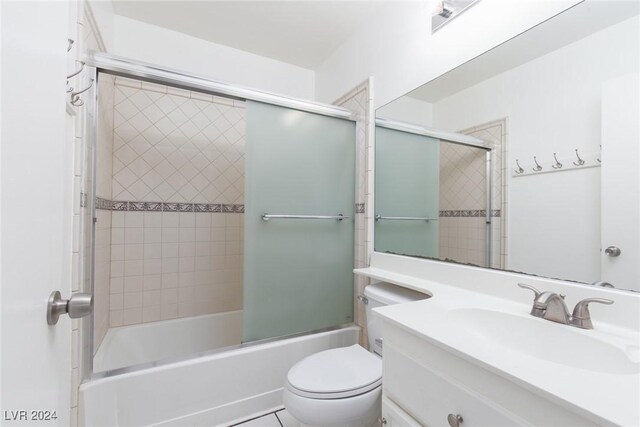 full bathroom with shower / bath combination with glass door, vanity, and toilet