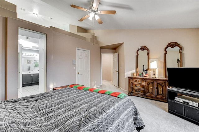 bedroom featuring light colored carpet, ceiling fan, vaulted ceiling, and connected bathroom