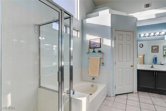 bathroom with tile patterned floors, plus walk in shower, and vanity