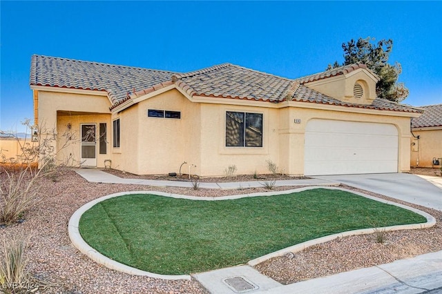 mediterranean / spanish-style home with a front lawn and a garage