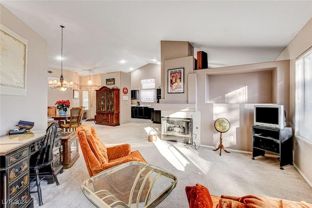 carpeted home office with vaulted ceiling and a chandelier