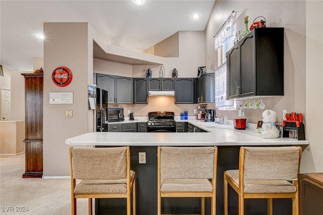 kitchen with a kitchen breakfast bar, black appliances, gray cabinetry, light colored carpet, and kitchen peninsula