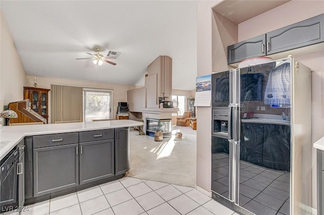 kitchen with kitchen peninsula, black appliances, gray cabinets, ceiling fan, and light carpet