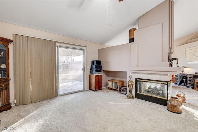 living room with a tile fireplace, light colored carpet, and high vaulted ceiling