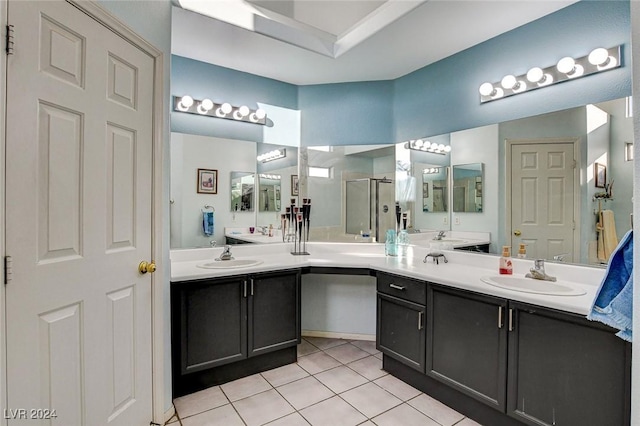 bathroom with an enclosed shower, vanity, and tile patterned floors