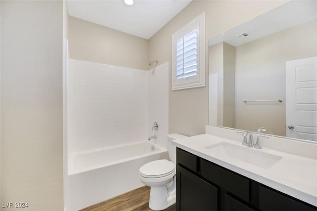 full bath with vanity,  shower combination, toilet, and wood finished floors