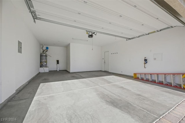 garage with strapped water heater, electric panel, and a garage door opener