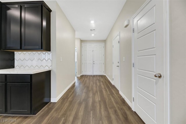 hallway featuring dark wood-style floors, visible vents, recessed lighting, and baseboards