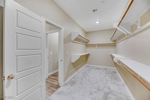 spacious closet with visible vents and carpet