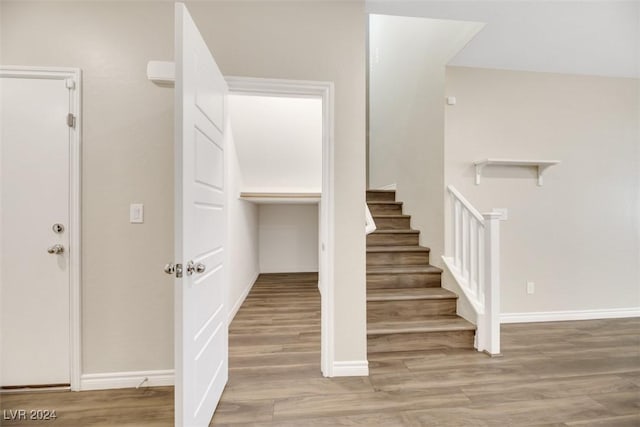 stairway featuring baseboards and wood finished floors