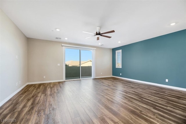 empty room featuring a ceiling fan, recessed lighting, wood finished floors, and baseboards