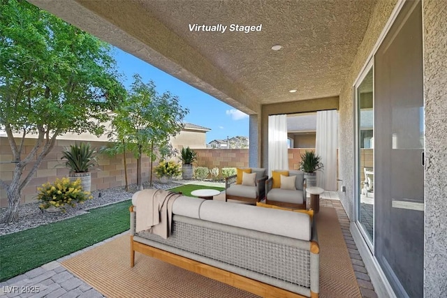 view of patio featuring an outdoor living space and a fenced backyard