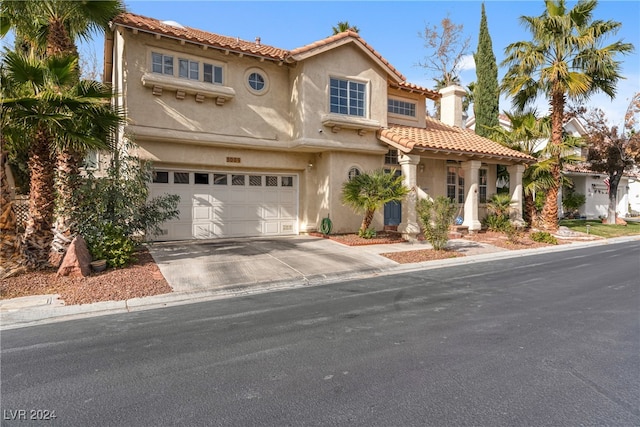 mediterranean / spanish home featuring a garage