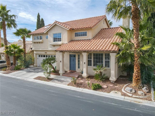 mediterranean / spanish-style house with a garage