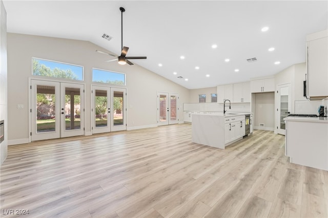 kitchen with french doors, white cabinets, sink, light hardwood / wood-style flooring, and ceiling fan