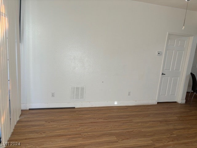 spare room with dark hardwood / wood-style flooring