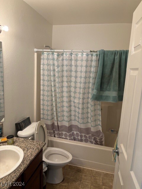 full bathroom with shower / tub combo, vanity, and toilet