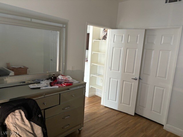 bedroom with a closet and light hardwood / wood-style floors