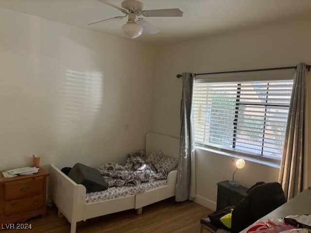 bedroom featuring wood-type flooring and ceiling fan