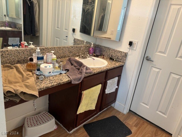 bathroom with vanity and hardwood / wood-style flooring