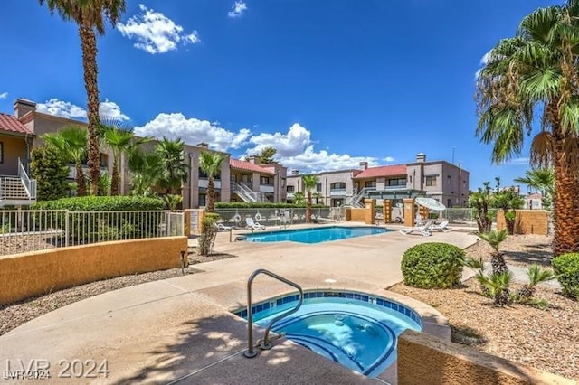 view of swimming pool with a community hot tub and a patio